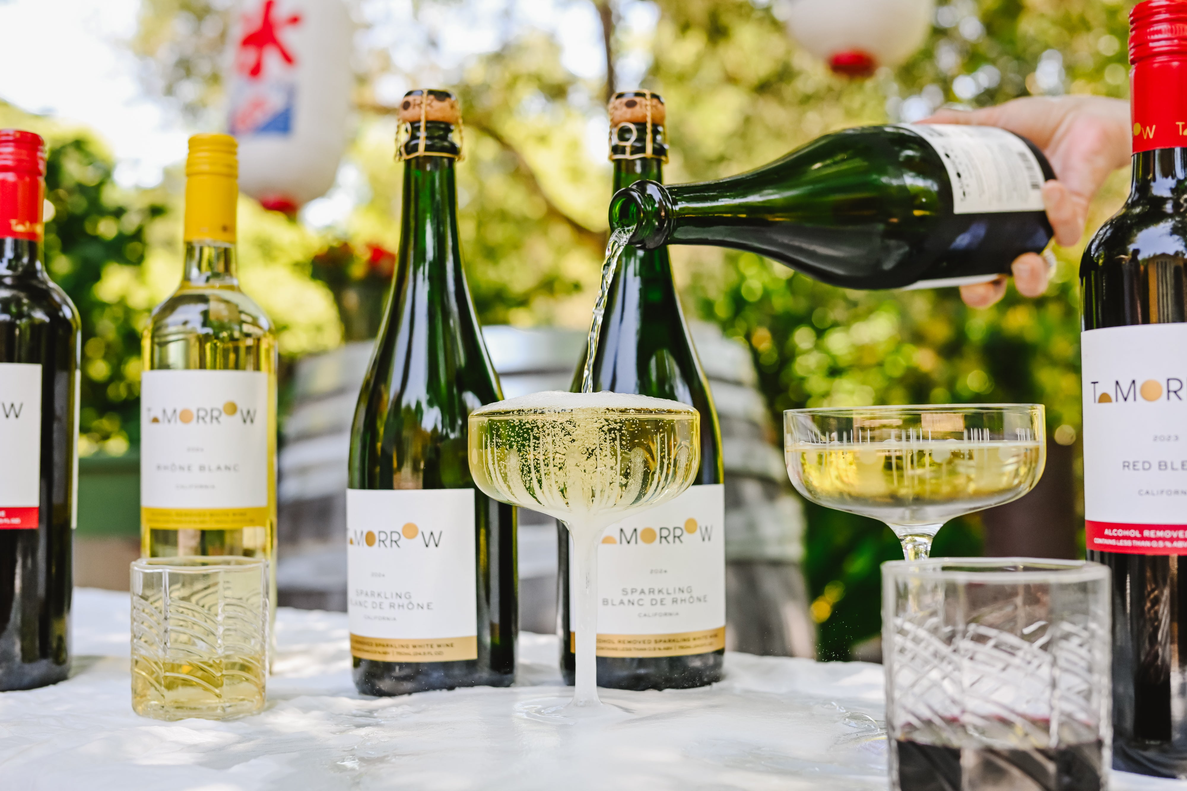 Bottles of Tomorrow Cellars non-alcoholic wines with glasses full