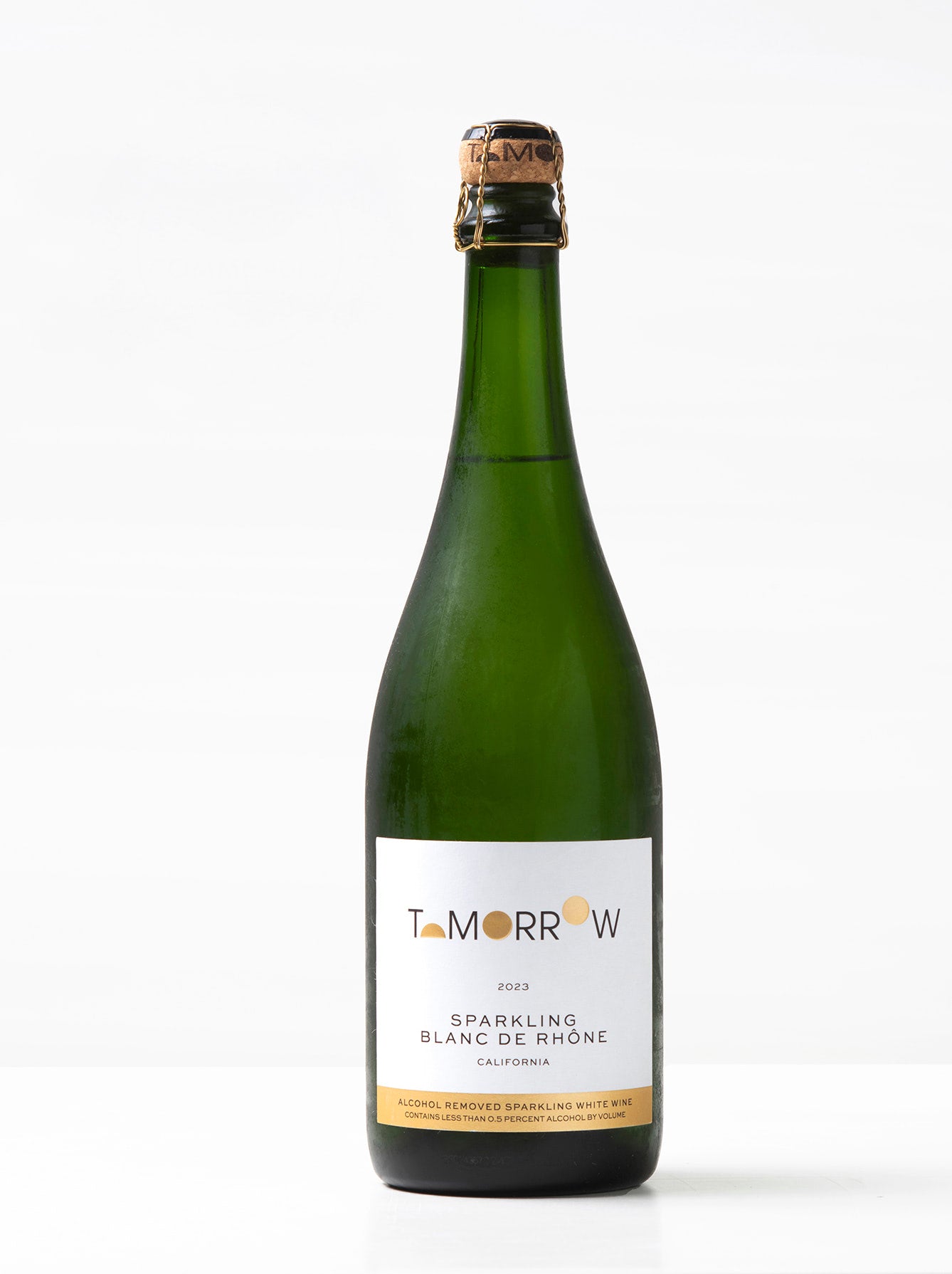 Bottle of Tomorrow Cellars 2023 Sparkling Blanc de Rhône – a non-alcoholic sparkling white wine made from Marsanne grapes. Pale gold with notes of pear, jasmine, citrus, and green apple; finishes with lemon meringue, apricot, yuzu, and wet stone.